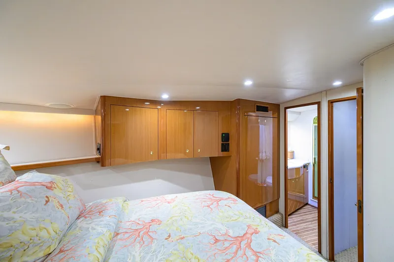 Island Girl Yacht Photos Pics Luxurious cabin interior of 2004 Viking 48 Convertible yacht with wood cabinetry and cozy bedding.