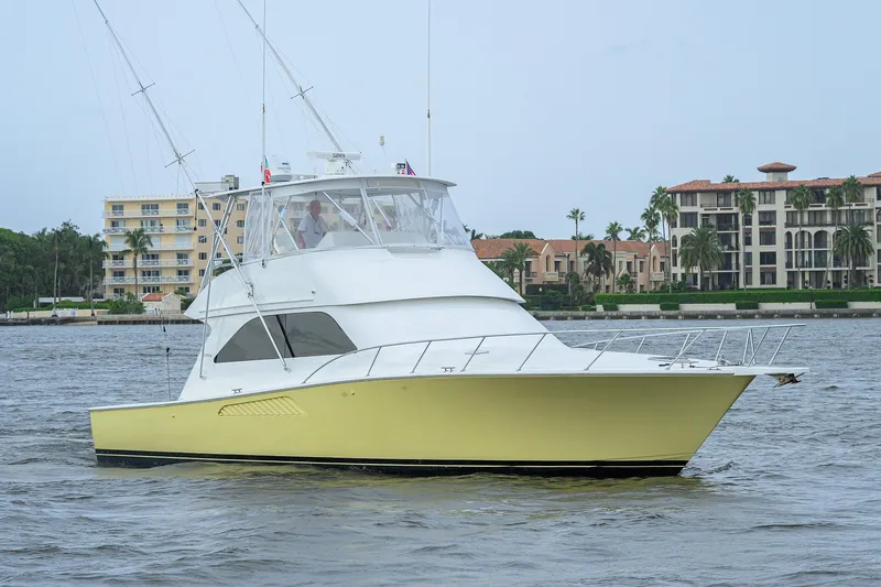 Island Girl Yacht Photos Pics 2004 Viking 48 Convertible yacht cruising near waterfront buildings.