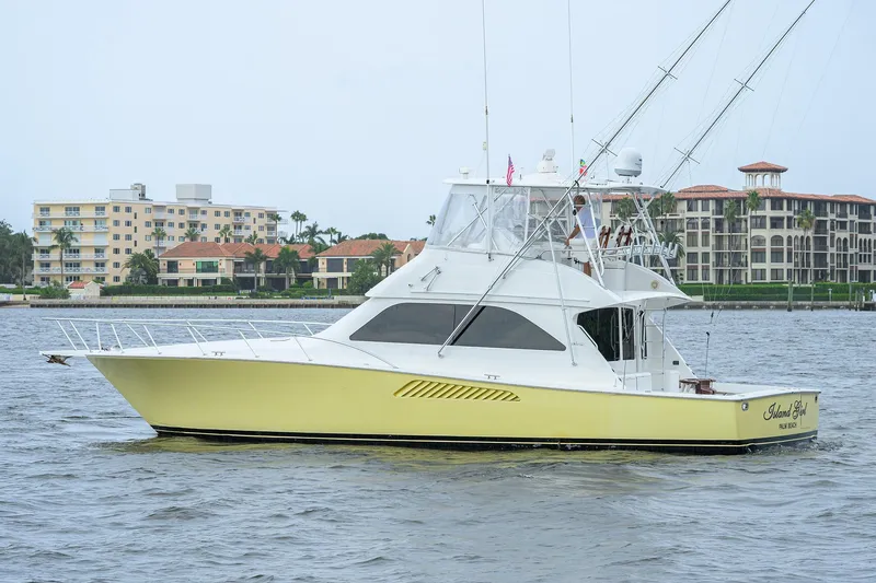 Island Girl Yacht Photos Pics 2004 Viking 48 Convertible yacht on water near luxury waterfront buildings.