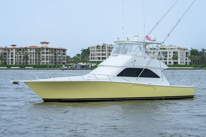 Island Girl Yacht Photos Pics 2004 Viking 48 Convertible yacht on water with luxury buildings in background.