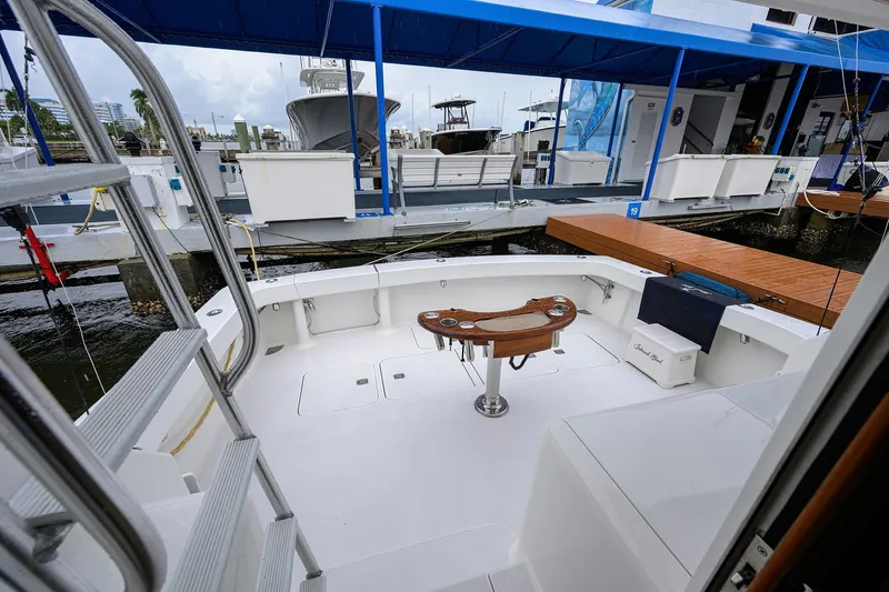 Island Girl Yacht Photos Pics 2004 Viking 48 Convertible yacht docked, featuring spacious deck and fishing chair.