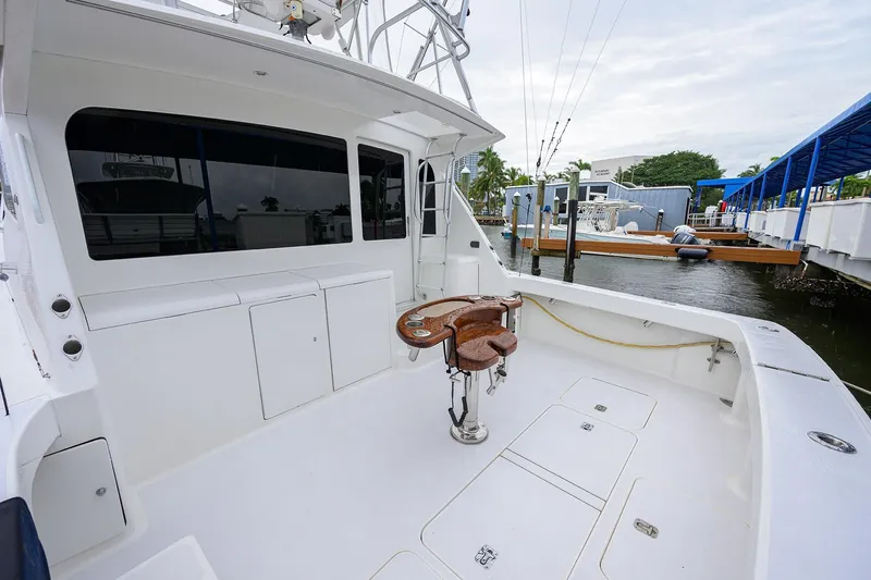 Island Girl Yacht Photos Pics 2004 Viking 48 Convertible yacht with spacious deck and fishing chair at marina.