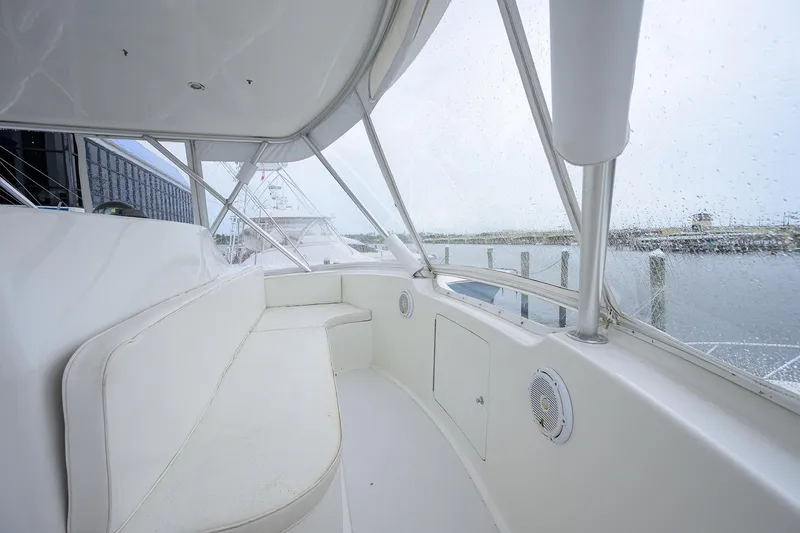 Island Girl Yacht Photos Pics 2004 Viking 48 Convertible yacht interior with white seating and marina view.