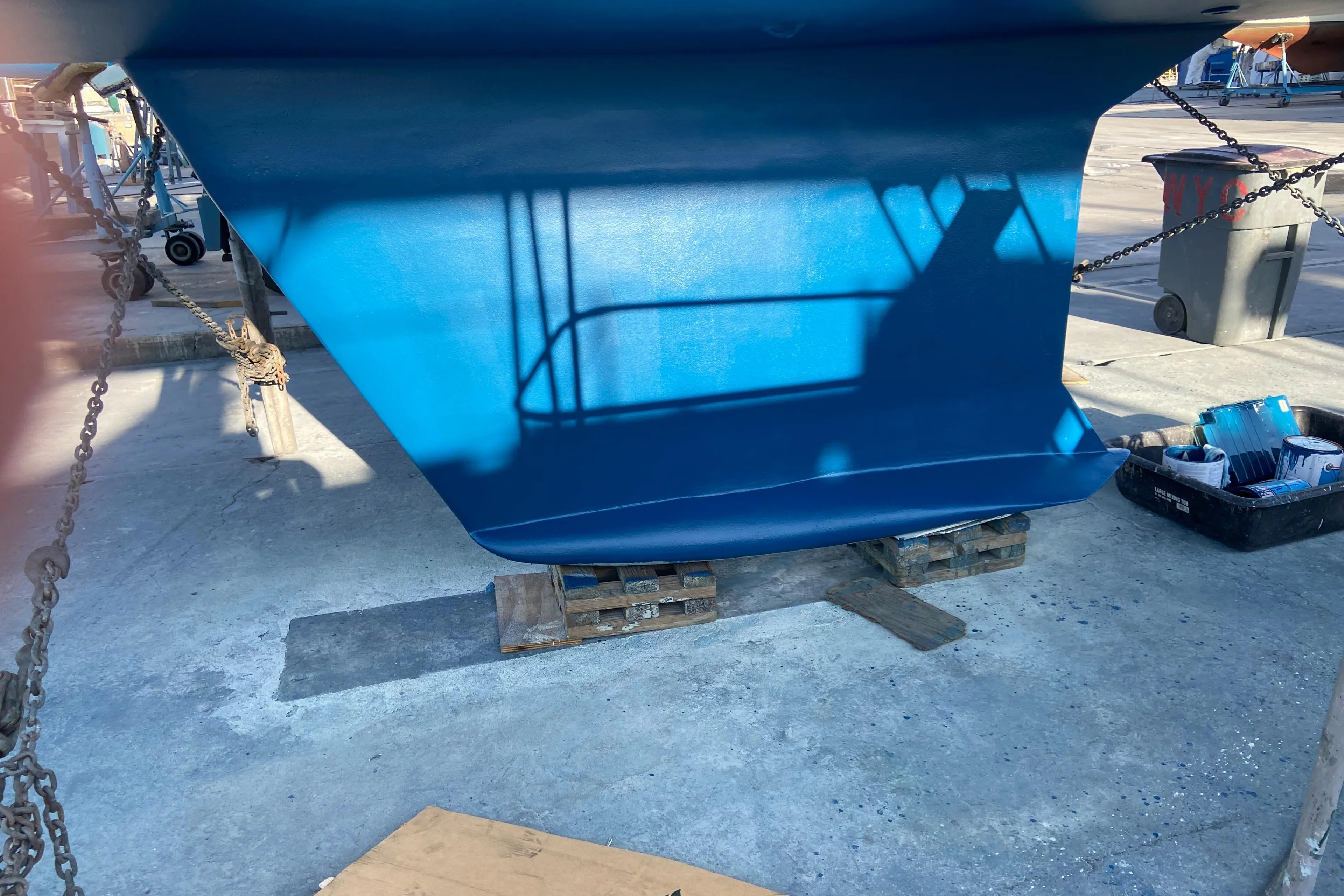 Blue hull of 2000 Hunter Passage 420 sailboat on dry dock.