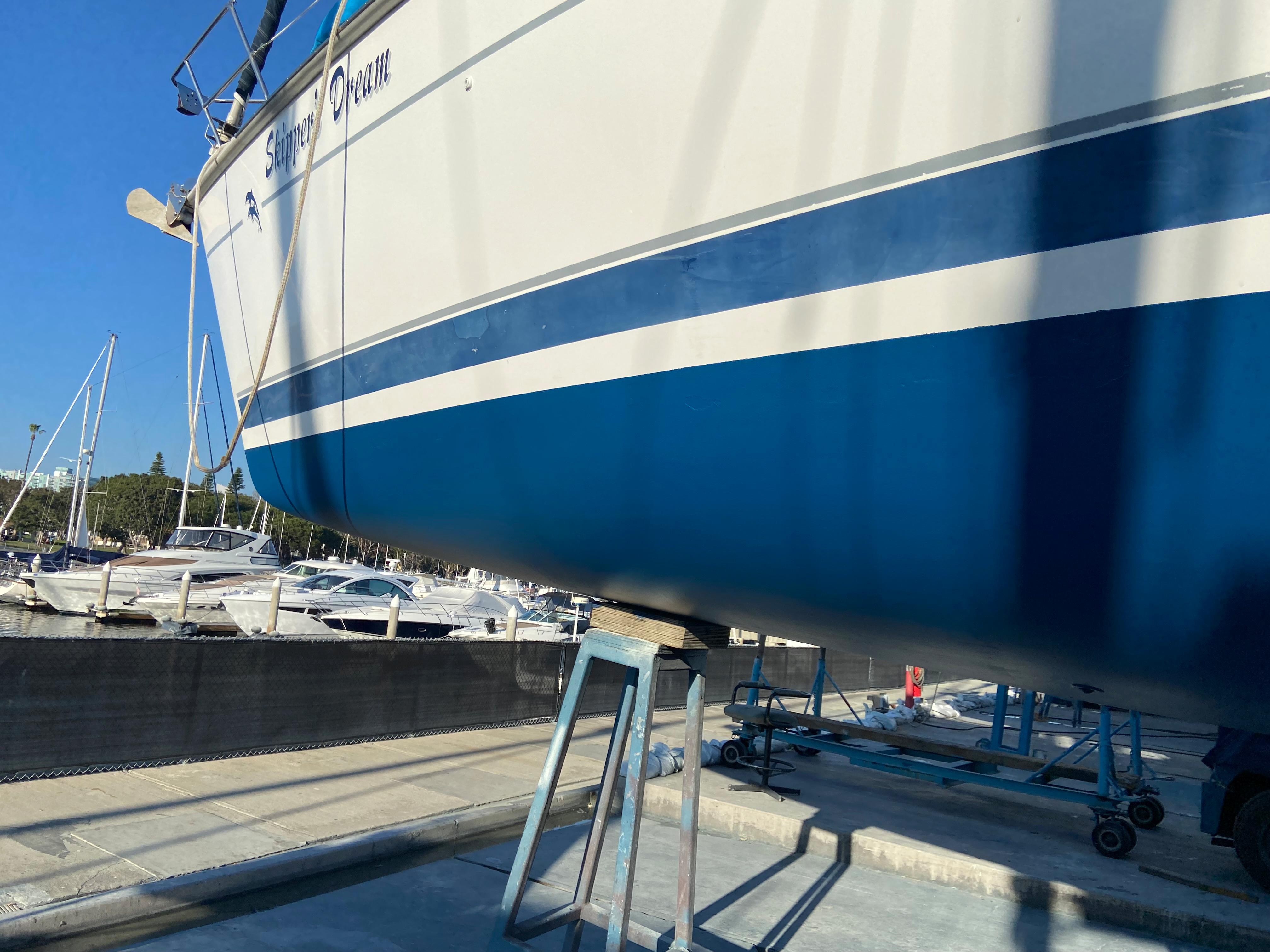 Hunter Passage 420 sailboat from 2000 on dry dock, with blue and white hull.