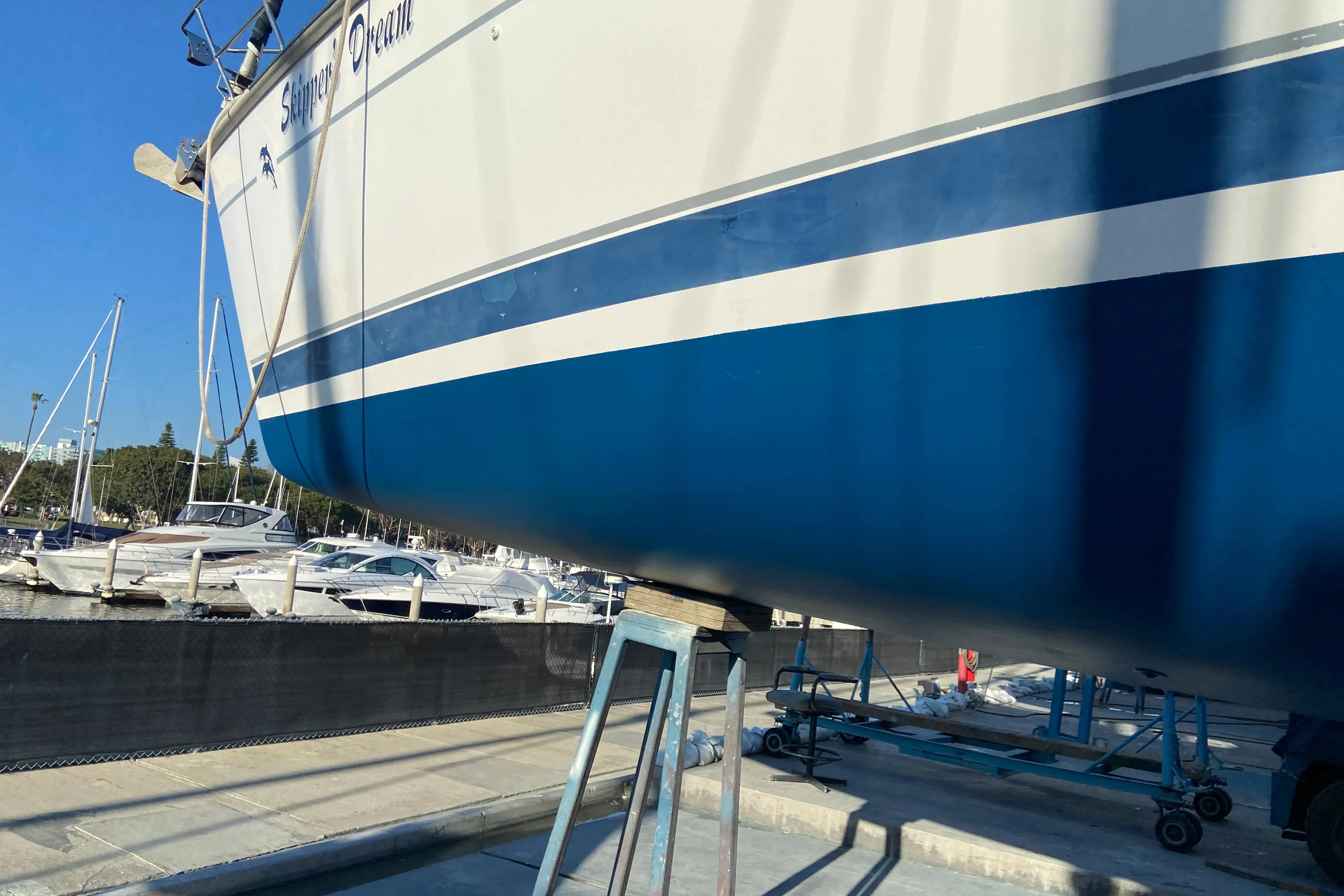 Hunter Passage 420 sailboat from 2000 on dry dock, with blue and white hull.
