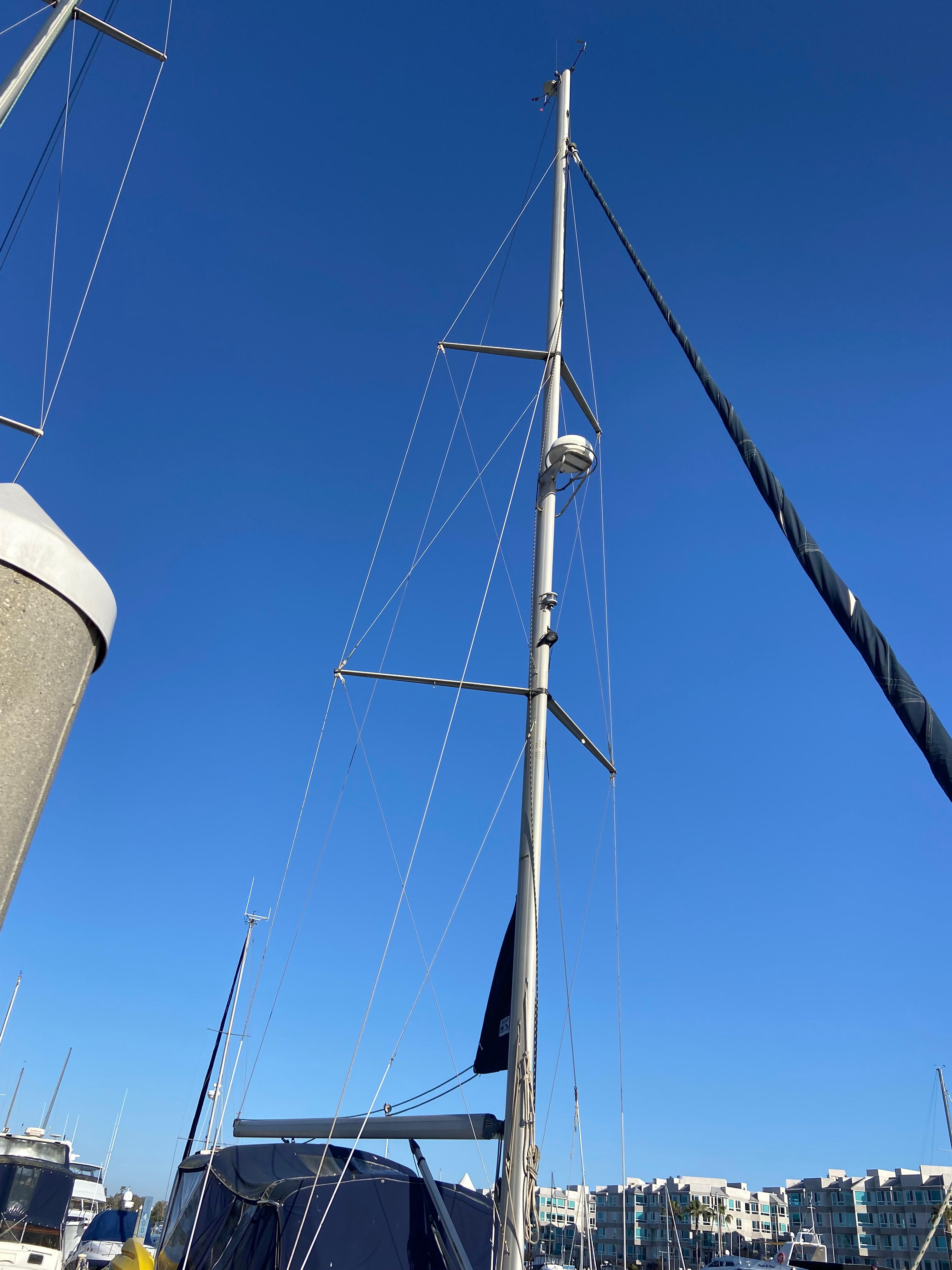 Sailboat mast of a 2000 Hunter Passage 420 against a clear blue sky.