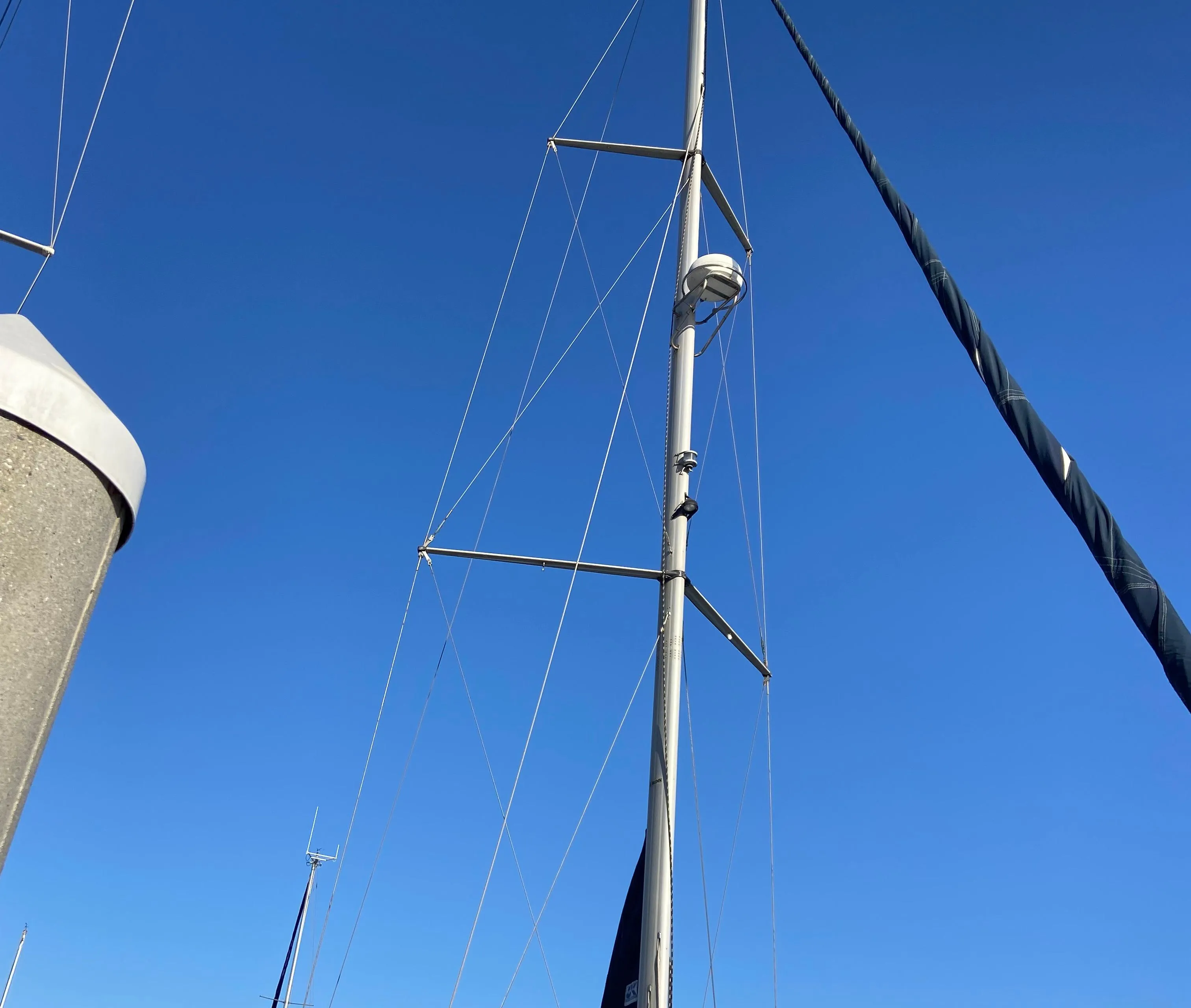 Sailboat mast of a 2000 Hunter Passage 420 against a clear blue sky.