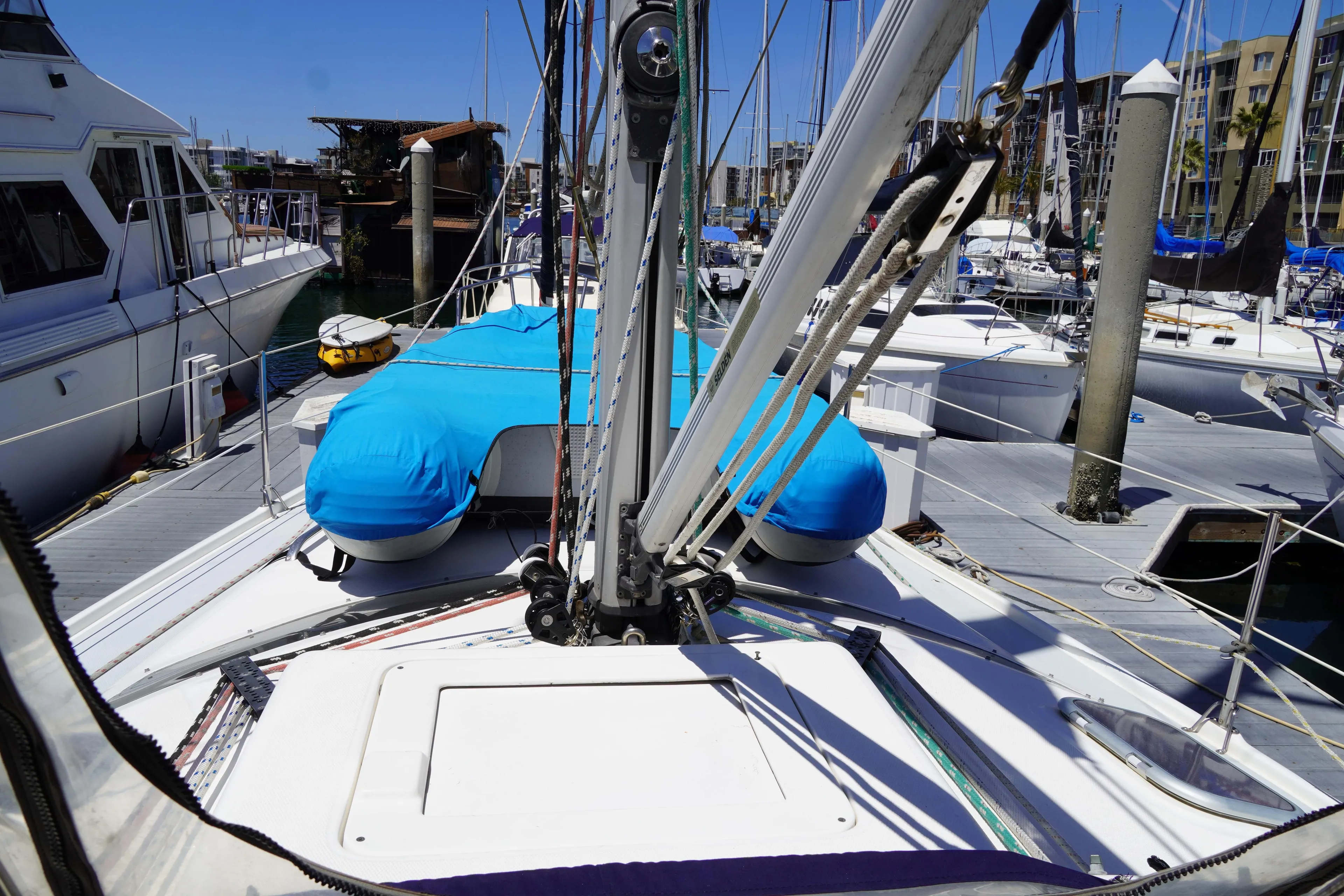 Hunter Passage 420 sailboat, 2000 model, docked in a marina with blue covers.