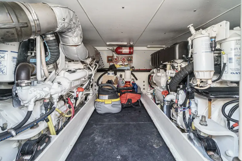 Nauti Pops Yacht Photos Pics Engine room of a 2007 Silverton Convertible yacht, showcasing dual engines and equipment.