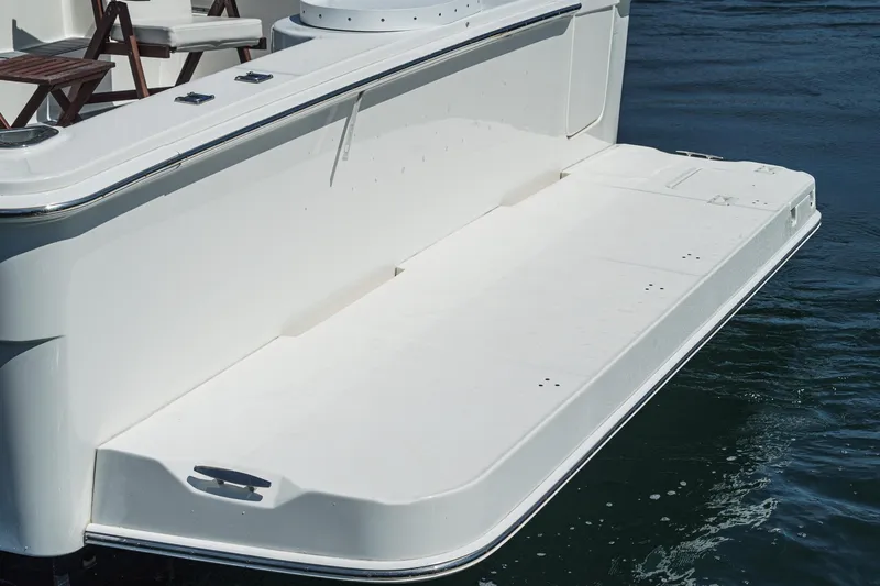 Nauti Pops Yacht Photos Pics 2007 Silverton Convertible boat swim platform on calm water.