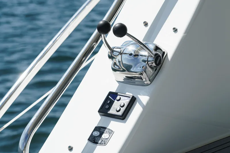 Nauti Pops Yacht Photos Pics 2007 Silverton Convertible boat controls with dual levers and buttons, against a water backdrop.