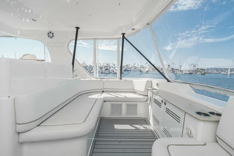 Nauti Pops Yacht Photos Pics Interior of 2007 Silverton Convertible yacht with ocean view and white seating.