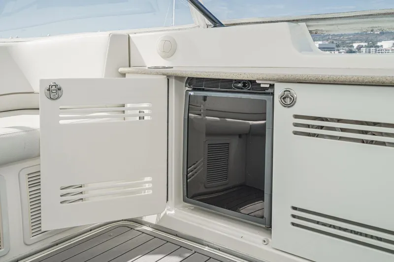 Nauti Pops Yacht Photos Pics 2007 Silverton Convertible yacht interior with open storage compartment and sleek design.