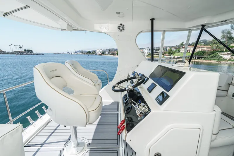 Nauti Pops Yacht Photos Pics 2007 Silverton Convertible yacht helm with modern controls and ocean view.