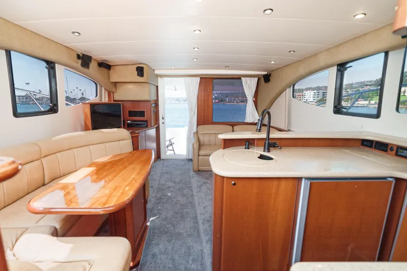 Nauti Pops Yacht Photos Pics Interior of a 2007 Silverton Convertible yacht with modern kitchen and seating area.