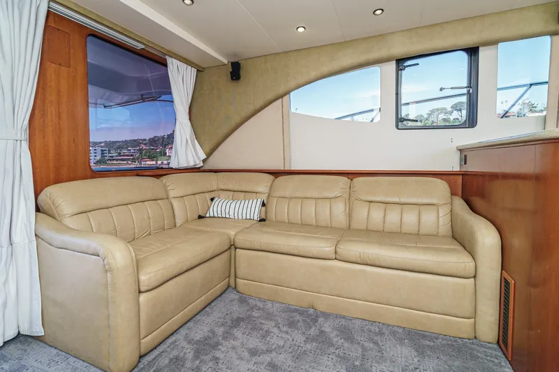 Nauti Pops Yacht Photos Pics Luxurious interior of a 2007 Silverton Convertible yacht with beige leather seating.