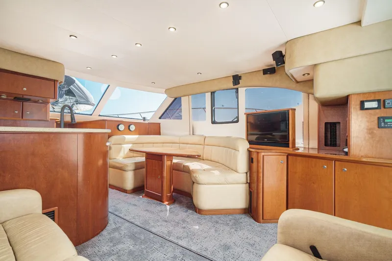Nauti Pops Yacht Photos Pics Luxurious interior of a 2007 Silverton Convertible yacht with plush seating and wooden cabinetry.