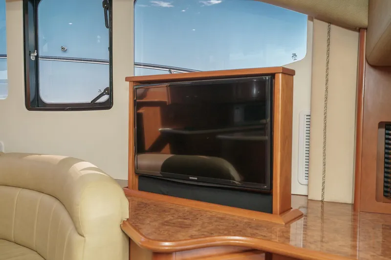 Nauti Pops Yacht Photos Pics Interior of a 2007 Silverton Convertible yacht featuring a TV and comfortable seating.