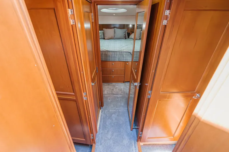 Nauti Pops Yacht Photos Pics Luxurious 2007 Silverton Convertible yacht interior with wooden cabinetry and cozy bedroom.