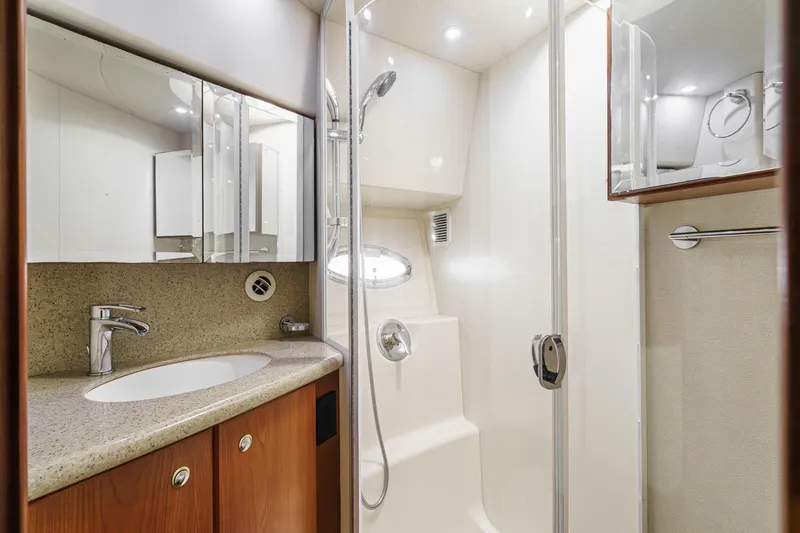 Nauti Pops Yacht Photos Pics Luxurious bathroom in 2007 Silverton Convertible yacht with modern fixtures and glass shower.