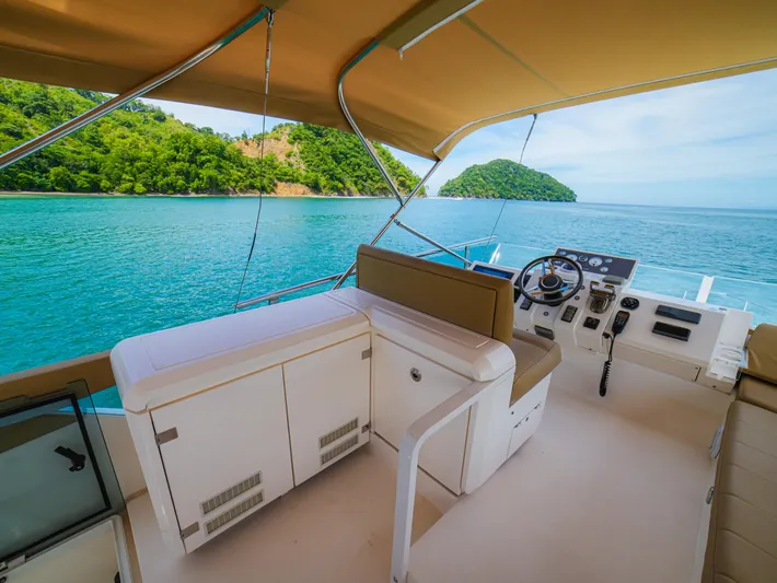 Yolo Yacht Photos Pics Fairline 50 yacht interior, 2014 model, with ocean view and lush green island backdrop.