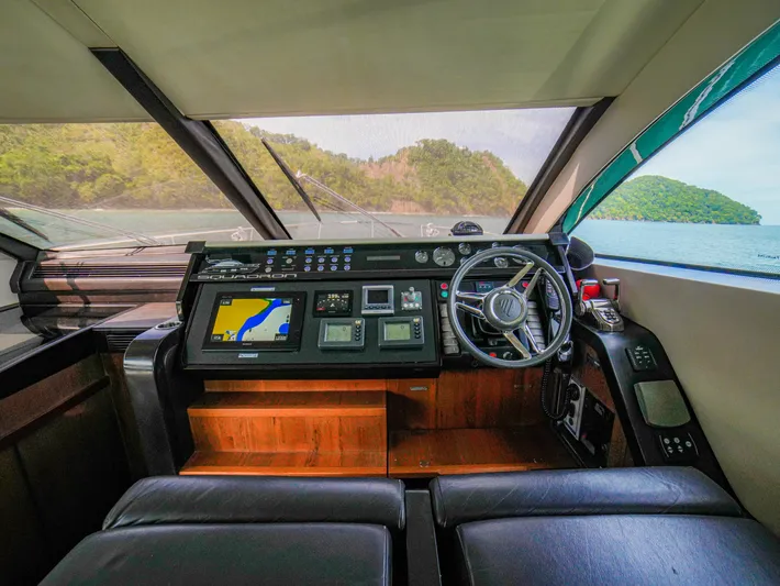Yolo Yacht Photos Pics Interior helm of 2014 Fairline 50 yacht with navigation equipment and scenic view.