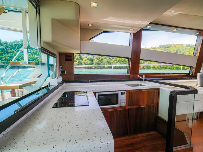 Yolo Yacht Photos Pics Luxurious 2014 Fairline 50 yacht kitchen with modern appliances and scenic views.