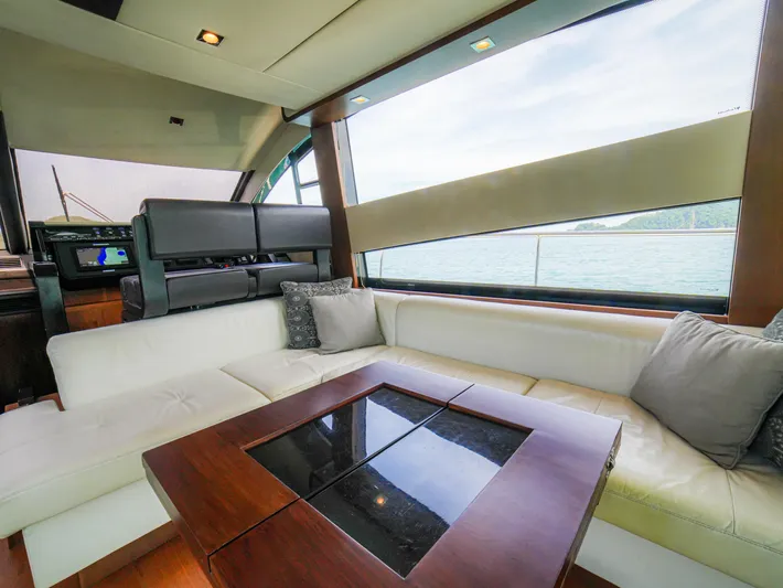 Yolo Yacht Photos Pics Luxurious interior of 2014 Fairline 50 yacht with plush seating and scenic window view.