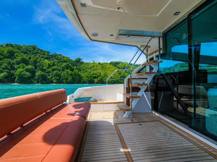 Yolo Yacht Photos Pics Luxurious 2014 Fairline 50 yacht deck with scenic ocean view and lush greenery.