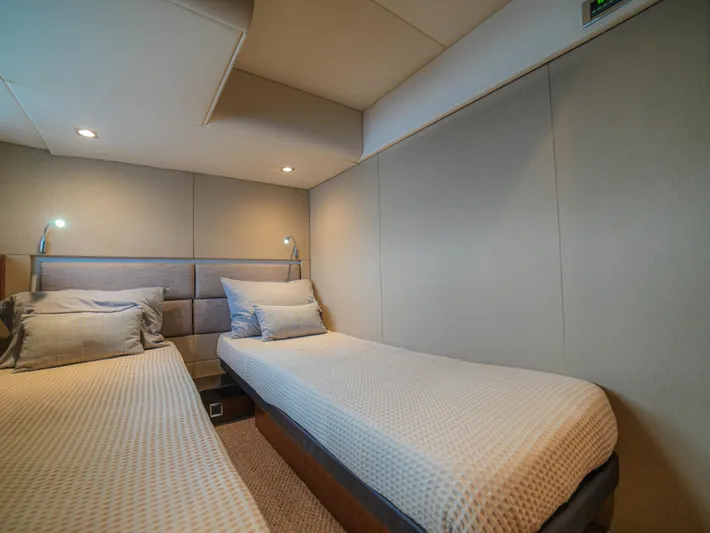 Yolo Yacht Photos Pics Cozy twin bedroom in 2014 Fairline 50 yacht with modern lighting and neutral decor.