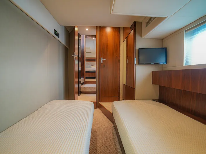 Yolo Yacht Photos Pics Luxurious cabin interior of 2014 Fairline 50 yacht with twin beds and TV.