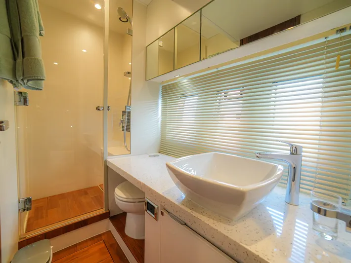 Yolo Yacht Photos Pics Luxurious bathroom in 2014 Fairline 50 yacht with modern fixtures and glass shower.