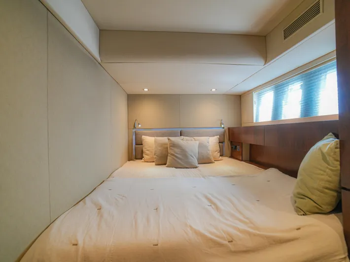 Yolo Yacht Photos Pics Luxurious bedroom interior of 2014 Fairline 50 yacht with cozy bedding and ambient lighting.