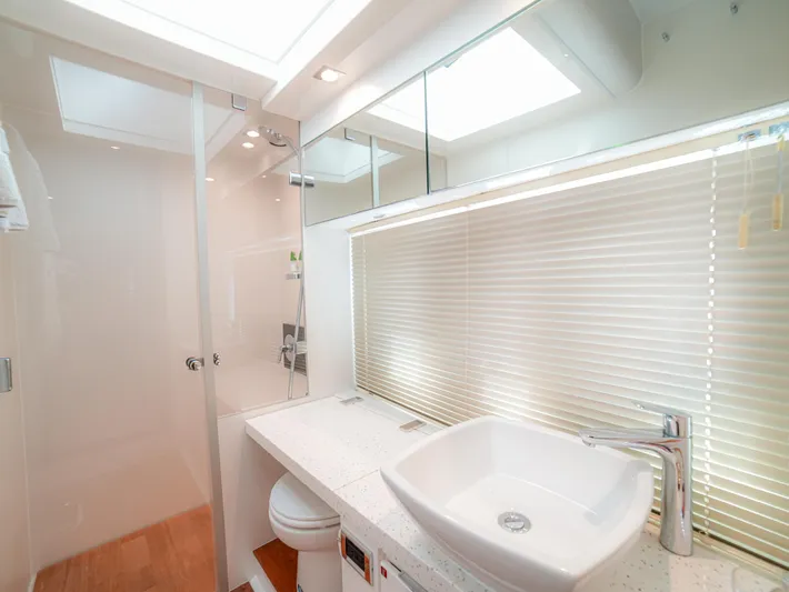 Yolo Yacht Photos Pics Luxurious bathroom in 2014 Fairline 50 yacht with modern fixtures and natural lighting.