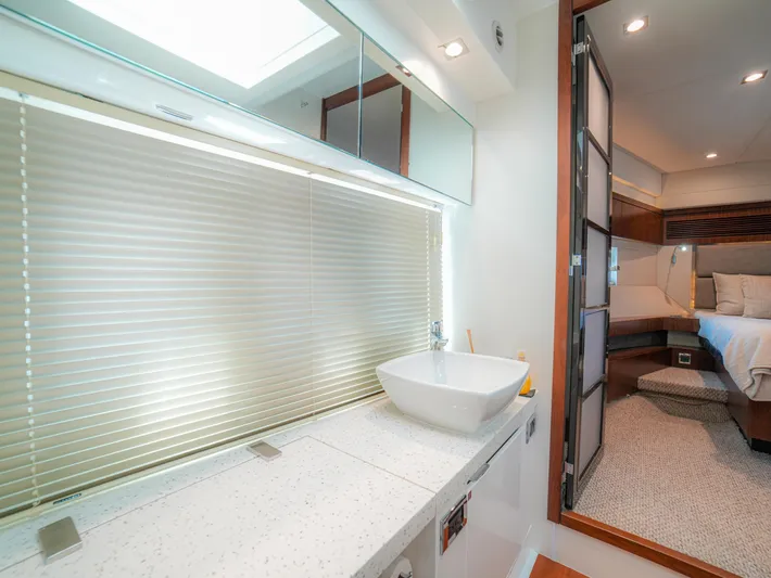 Yolo Yacht Photos Pics Luxurious bathroom and bedroom in 2014 Fairline 50 yacht, featuring modern design and amenities.