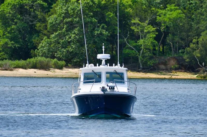  Yacht Photos Pics 2021 Steiger Craft 31 Chesapeake boat cruising on a serene lake.