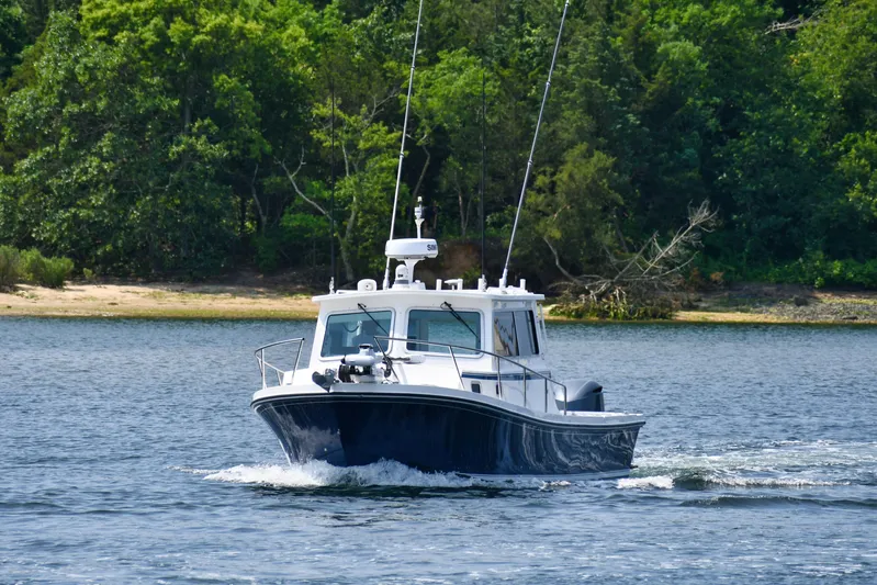  Yacht Photos Pics 2021 Steiger Craft 31 Chesapeake boat cruising on a scenic lake.