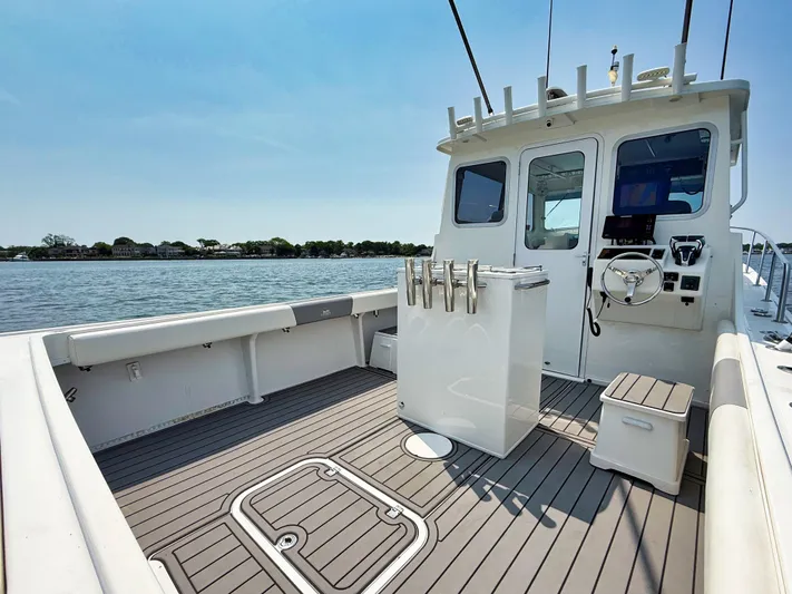  Yacht Photos Pics 2021 Steiger Craft 31 Chesapeake boat interior with fishing rod holders and steering wheel.