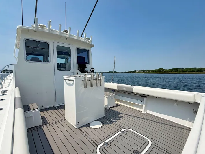  Yacht Photos Pics 2021 Steiger Craft 31 Chesapeake boat on calm water, featuring spacious deck and modern design.