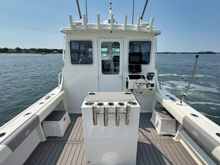  Yacht Photos Pics 2021 Steiger Craft 31 Chesapeake boat interior with fishing rod holders on calm water.