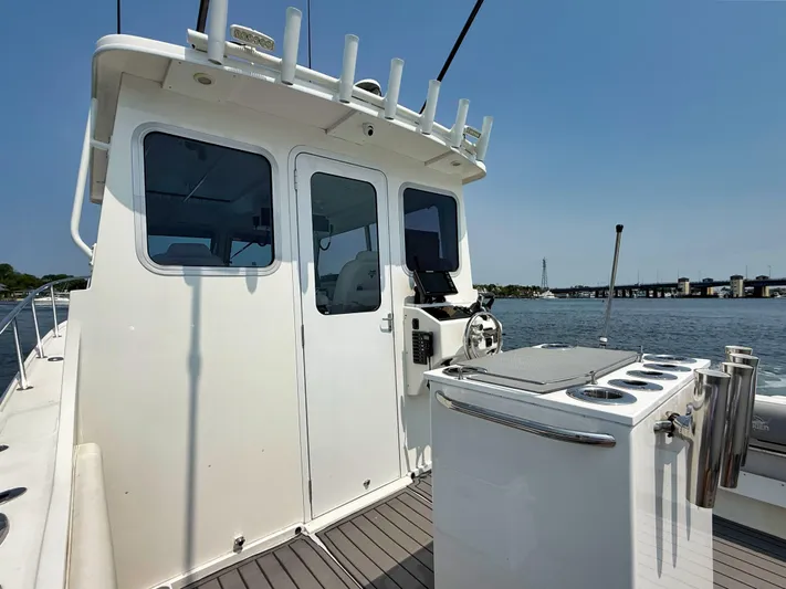  Yacht Photos Pics 2021 Steiger Craft 31 Chesapeake boat on water, featuring helm and fishing rod holders.