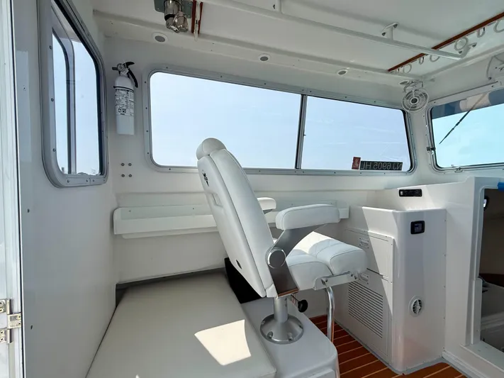  Yacht Photos Pics Interior of 2021 Steiger Craft 31 Chesapeake boat with white seating and large windows.