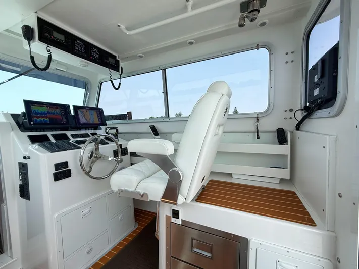  Yacht Photos Pics 2021 Steiger Craft 31 Chesapeake helm with modern navigation equipment and comfortable seating.