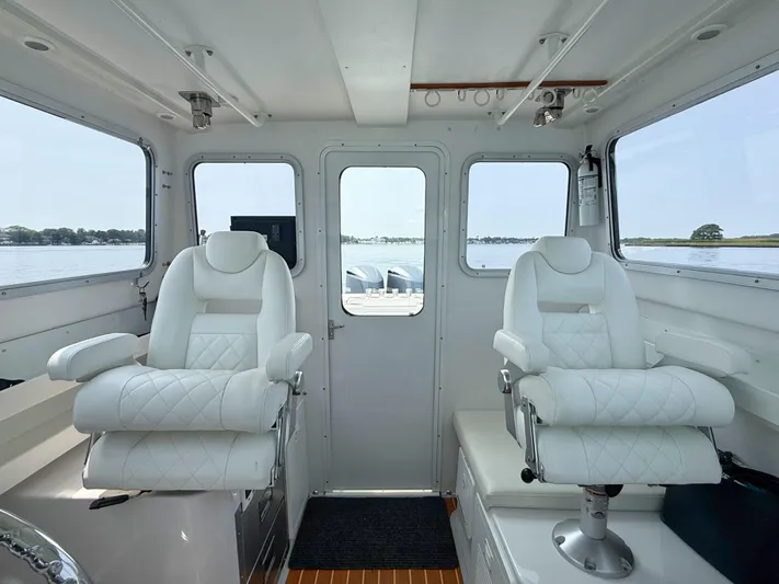  Yacht Photos Pics Interior of 2021 Steiger Craft 31 Chesapeake boat with luxurious white seating.
