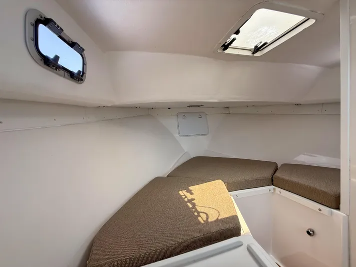 Yacht Photos Pics 2021 Steiger Craft 31 Chesapeake cabin interior with cushioned seating and windows.