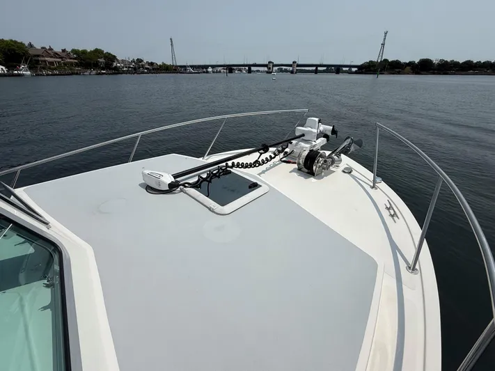  Yacht Photos Pics 2021 Steiger Craft 31 Chesapeake boat deck with anchor, on calm water near a bridge.