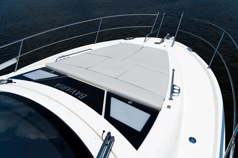  Yacht Photos Pics 2022 Bavaria SR41 yacht deck with sunbathing area, sleek design, and railing.