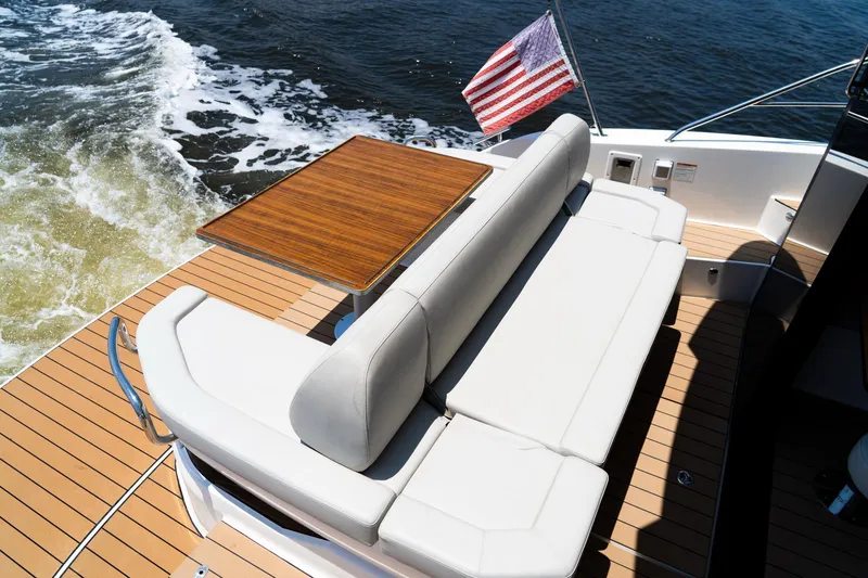  Yacht Photos Pics Luxury Bavaria SR41 yacht deck with seating, table, and American flag, 2022 model.
