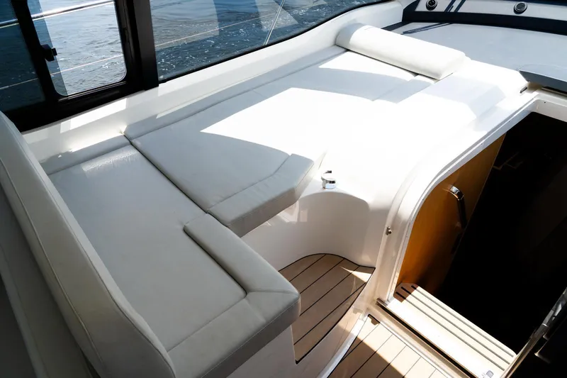  Yacht Photos Pics 2022 Bavaria SR41 yacht interior with white seating and wooden flooring.